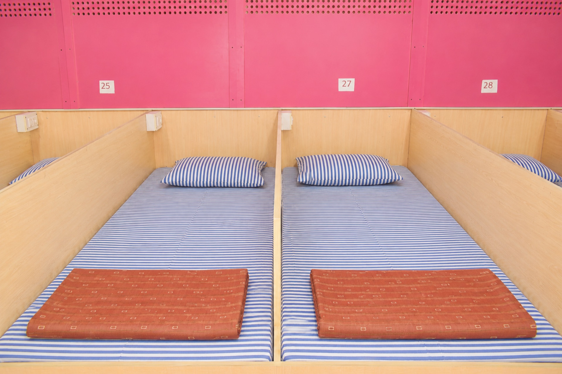 AC Dormitory individual partitioned beds with linen, pillows and charging points