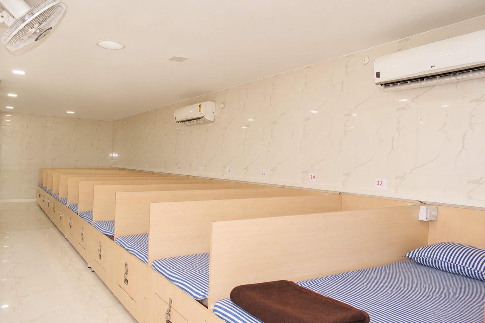 Spacious AC Dormitory hall with numbered cubicles and under-bed storage
