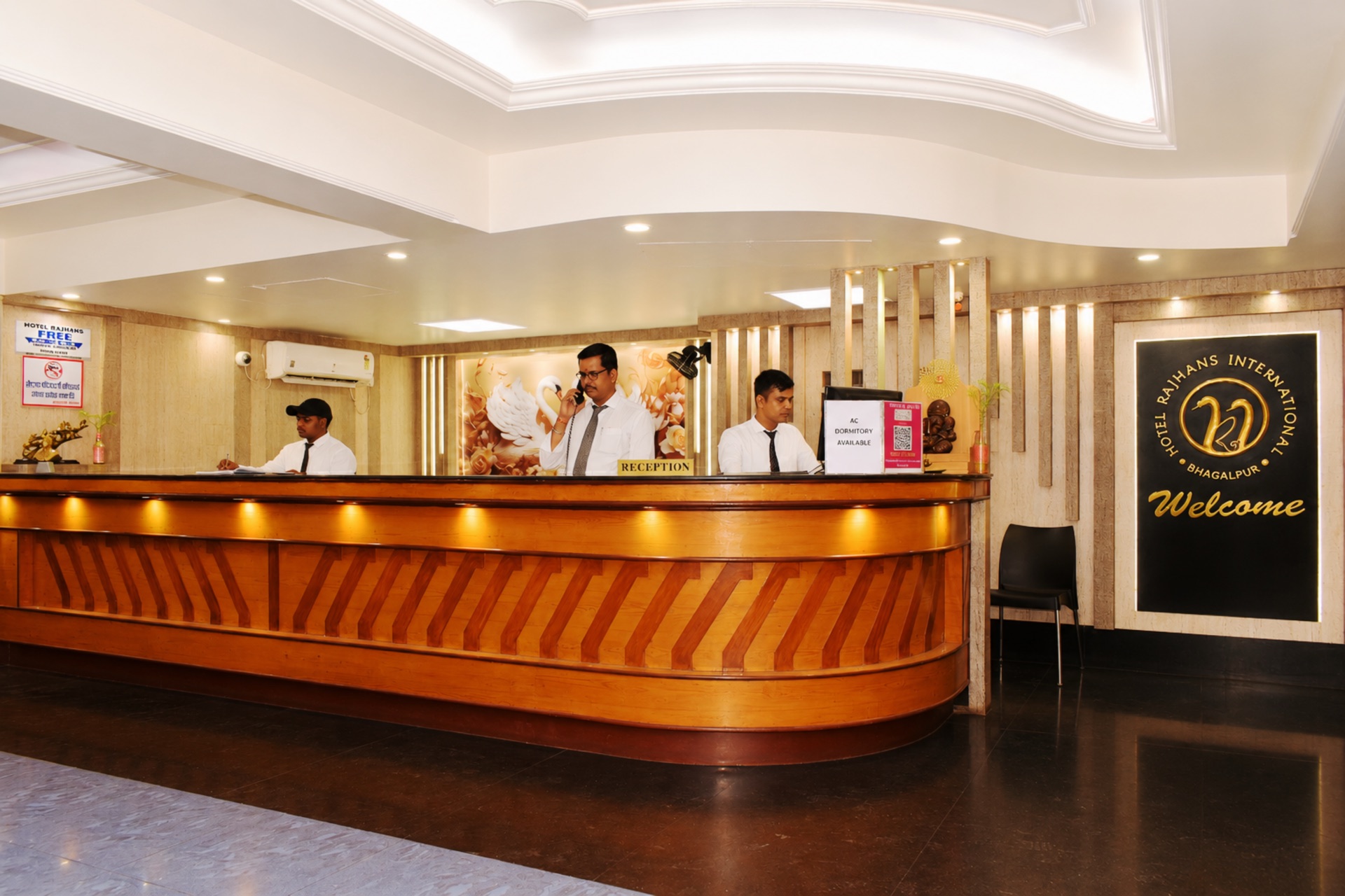 Hotel Rajhans International 24/7 front desk with uniformed reception staff