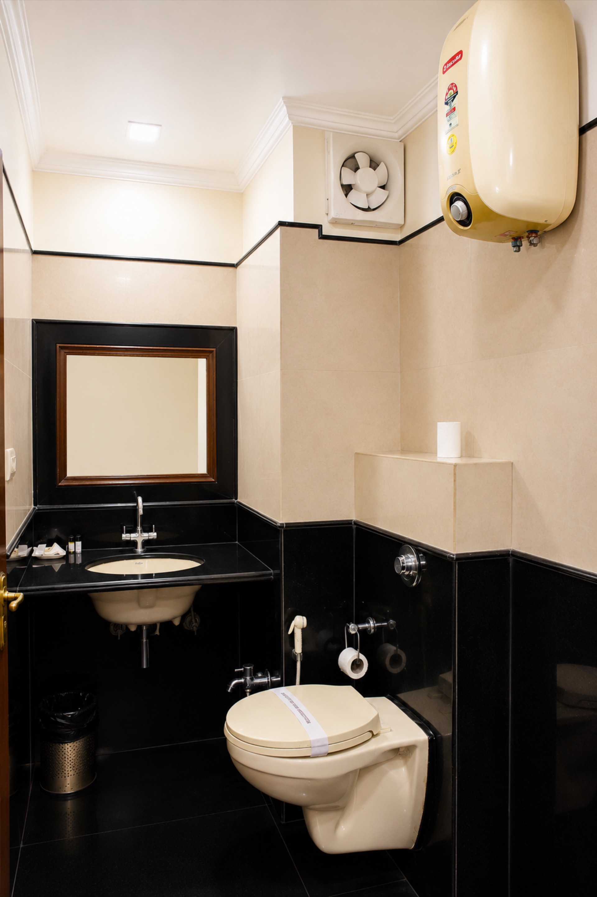 Royal Suite en-suite bathroom with granite vanity counter, mirror and geyser